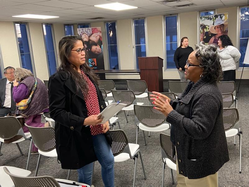 FCC Consumer Outreach Specialist Alma Hughes answers questions from an attendee after a HELP New Mexico consumer education event in Albuquerque on Friday.