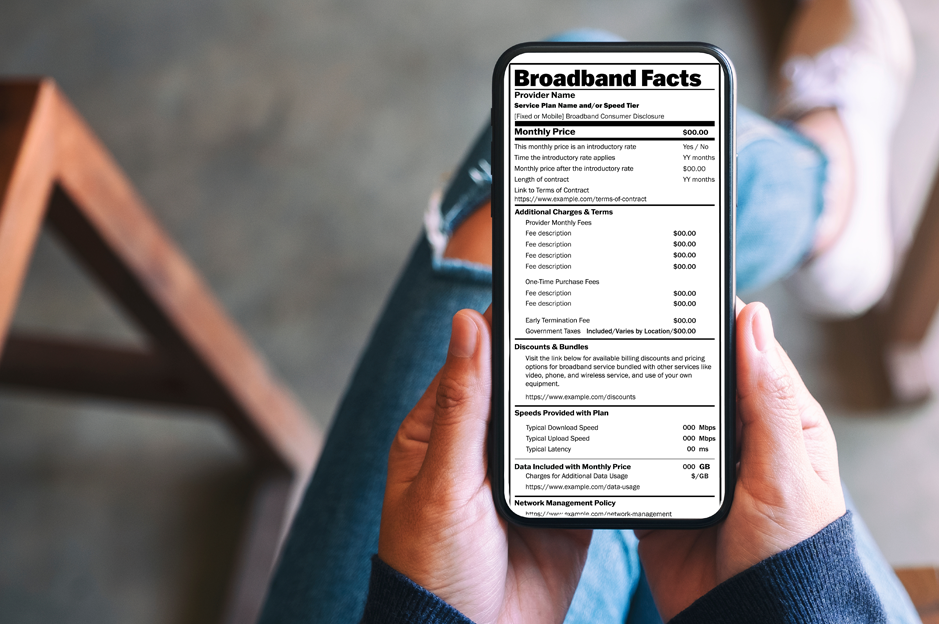 person holding a phone showing a broadband label