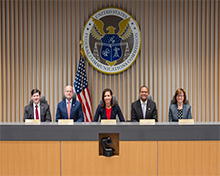 Commissioners group photo in commission meeting room at FCC's Washington DC headquarters, December 13, 2024, L to R: Commissioner Nathan Simington, Commissioner Brendan Carr, Chairwoman Jessica Rosenworcel, Commissioner Geoffrey Starks, and Commissioner Anna Gomez